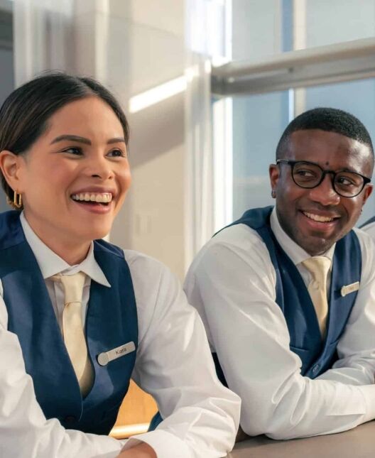 Boosting Employee Engagement_ 3 Key Benefits of Prioritizing Mental Health in the Hospitality Industry A woman is sitting at a table with her head on the table.